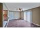 Open concept living room with wood-look floors and sliding glass doors to a patio at 809 High Meadow Ln # F, Charlotte, NC 28217