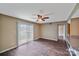 Bright living room boasts wood-look floors, ceiling fan, and sliding glass doors at 809 High Meadow Ln # F, Charlotte, NC 28217