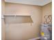 A well-lit storage room featuring a shelf, access to plumbing and a water heater at 809 High Meadow Ln # F, Charlotte, NC 28217