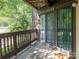 Outdoor balcony with wood railings and entry door at 8208 Cedar Glen Dr, Charlotte, NC 28212