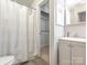 Updated bathroom featuring neutral walls and cabinets, updated fixtures, and a walk-in closet at 8208 Cedar Glen Dr, Charlotte, NC 28212