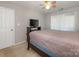 Cozy bedroom with ceiling fan, TV, and vertical blinds for a relaxing ambiance at 8208 Cedar Glen Dr, Charlotte, NC 28212