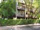 Multi-story condominium exterior with balconies, wood siding, and mature landscaping at 8208 Cedar Glen Dr, Charlotte, NC 28212