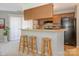 Bright kitchen featuring a breakfast bar with seating and black appliances at 8208 Cedar Glen Dr, Charlotte, NC 28212