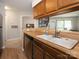 Functional kitchen features wood cabinets and a view to the living area, great for entertaining at 8208 Cedar Glen Dr, Charlotte, NC 28212
