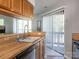 Bright kitchen featuring wood cabinetry, a stainless steel dishwasher, and a view to the porch at 8208 Cedar Glen Dr, Charlotte, NC 28212