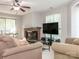 Bright living room with a fireplace, comfortable sofas, and a ceiling fan at 8208 Cedar Glen Dr, Charlotte, NC 28212