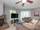 Inviting living room with a fireplace, comfortable seating, and a large TV at 8208 Cedar Glen Dr, Charlotte, NC 28212