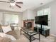 Cozy living room features a fireplace, neutral colors, and natural light through large windows at 8208 Cedar Glen Dr, Charlotte, NC 28212