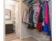 Bright walk-in closet provides ample storage for clothing, with bathroom access at 8208 Cedar Glen Dr, Charlotte, NC 28212