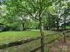 Spacious backyard with lush greenery, wooden fence, and shed; a perfect outdoor retreat at 823 Corbin St, Albemarle, NC 28001