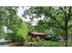 Cozy single story home featuring a wood exterior, mature trees, and a well maintained front yard at 823 Corbin St, Albemarle, NC 28001
