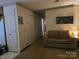 Living room with beige sofa, carpet, and a view of the hallway leading to other rooms at 823 Corbin St, Albemarle, NC 28001