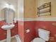 Charming powder room with a pedestal sink, decorative wallpaper, and a toilet at 9564 Kings Parade Blvd, Charlotte, NC 28273