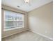 Bright bedroom featuring a light ceiling fan, and large window at 9564 Kings Parade Blvd, Charlotte, NC 28273