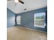 Cozy bedroom featuring two windows, neutral carpet, and blue walls at 9564 Kings Parade Blvd, Charlotte, NC 28273