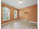 Cozy bedroom features modern wood-look flooring and bright windows at 9564 Kings Parade Blvd, Charlotte, NC 28273