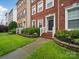 Beautiful townhome features manicured landscaping, a brick facade, and well-maintained front yard at 9564 Kings Parade Blvd, Charlotte, NC 28273