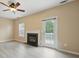 Living room with fireplace, ceiling fan, and backyard access at 9564 Kings Parade Blvd, Charlotte, NC 28273