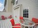 Back patio features outdoor seating and a glass table at 9564 Kings Parade Blvd, Charlotte, NC 28273