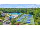 Aerial view of community pool, waterslide, playground, kiddie pool and tennis/pickleball courts at 9800 Walkers Glen Nw Dr, Concord, NC 28027