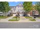 Charming townhomes feature manicured lawns, individual driveways, and inviting entrances with brick and siding facades at 9800 Walkers Glen Nw Dr, Concord, NC 28027
