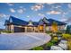 Beautiful home with a stone and stucco exterior, manicured landscaping, and an expansive driveway at 0 Edgewater Dr # 107, Norwood, NC 28128