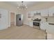 A bright kitchen with white cabinets, stainless steel appliances, and modern lighting at 1003 S Ridge Ave, Kannapolis, NC 28083