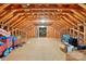 Spacious attic featuring exposed wood beams and flooring with Christmas decor at 102 Rosewood Ln, Locust, NC 28097