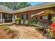 This brick patio area offers outdoor relaxation and overlooks beautifully landscaped grounds and the rear exterior of the home at 102 Rosewood Ln, Locust, NC 28097