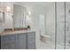 Contemporary bathroom with a glass shower enclosure and a gray vanity at 102 Rosewood Ln, Locust, NC 28097