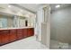 Bathroom featuring a double vanity with a tile shower at 102 Rosewood Ln, Locust, NC 28097