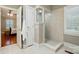 Bathroom with tile shower, tile floor, and a view into the adjacent bedroom at 102 Rosewood Ln, Locust, NC 28097