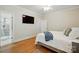 Bright bedroom with hardwood floors and a walk-in tile shower at 102 Rosewood Ln, Locust, NC 28097