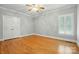 An empty bedroom with hardwood floors, shutters, and a double closet at 102 Rosewood Ln, Locust, NC 28097