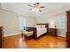 Inviting bedroom with hardwood flooring, neutral colors, and natural light at 102 Rosewood Ln, Locust, NC 28097
