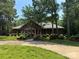 Charming single-story brick home with well-manicured landscaping and a circular driveway at 102 Rosewood Ln, Locust, NC 28097
