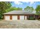 Large three-car garage offers ample parking and storage space, complementing the brick exterior at 102 Rosewood Ln, Locust, NC 28097