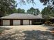 Spacious three-car garage with a concrete driveway, attached to a brick home at 102 Rosewood Ln, Locust, NC 28097