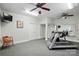Home gym with a treadmill, mirrored wall, ceiling fans, and neutral colored walls and carpet at 102 Rosewood Ln, Locust, NC 28097
