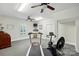 Bright home gym featuring exercise equipment, a ceiling fan, and a window for natural light at 102 Rosewood Ln, Locust, NC 28097
