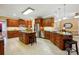 Expansive kitchen with custom wood cabinetry, granite countertops, stainless steel appliances, and a large island with seating at 102 Rosewood Ln, Locust, NC 28097