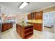 Spacious kitchen featuring granite countertops, custom wood cabinets, and an island, perfect for Gathering gatherings at 102 Rosewood Ln, Locust, NC 28097