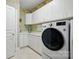 Functional laundry room with ample white cabinetry, sink, countertop space, and modern appliances at 102 Rosewood Ln, Locust, NC 28097