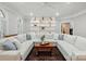 Spacious living room featuring a large sectional sofa, a decorative bookshelf, and a bright, inviting atmosphere at 102 Rosewood Ln, Locust, NC 28097