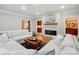 Cozy living room featuring a stone fireplace, comfortable seating, and an open view into adjacent rooms at 102 Rosewood Ln, Locust, NC 28097