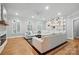 Bright and airy living room with hardwood floors, built-in bookshelves, a cozy fireplace, and plush white seating at 102 Rosewood Ln, Locust, NC 28097