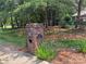 Brick mailbox with house number, surrounded by lush greenery and pine straw at 102 Rosewood Ln, Locust, NC 28097