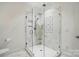 A shower featuring marble tiles and glass door at 102 Rosewood Ln, Locust, NC 28097