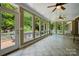 Bright sun room with tile flooring, a ceiling fan, and lots of windows overlooking the backyard at 102 Rosewood Ln, Locust, NC 28097